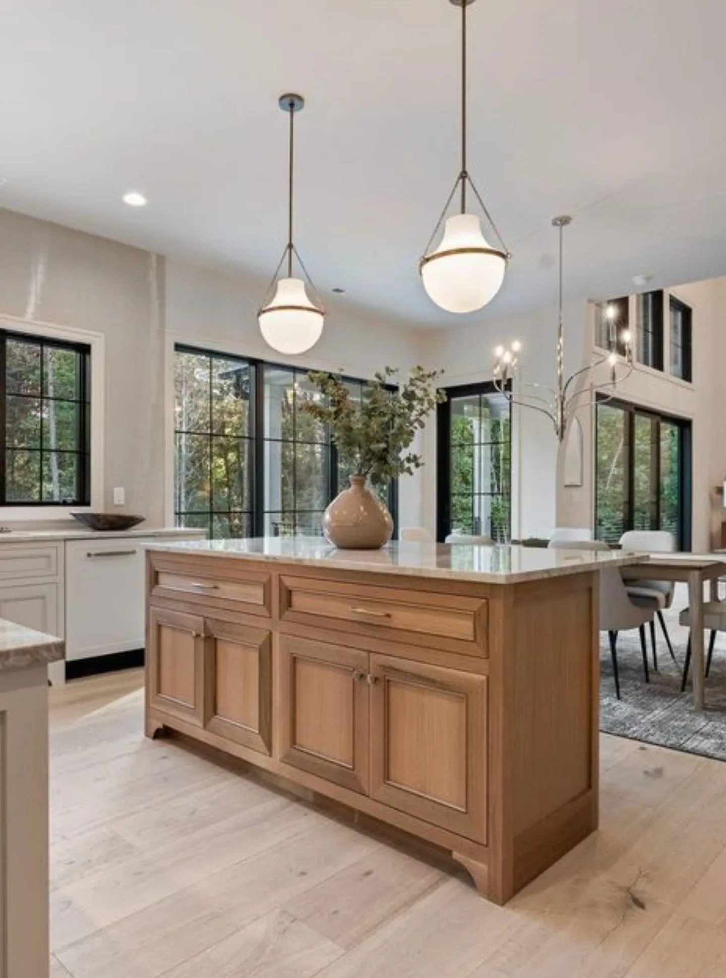A stained oak kitchen island with inset raised panel doors, drawers and curved furniture feet